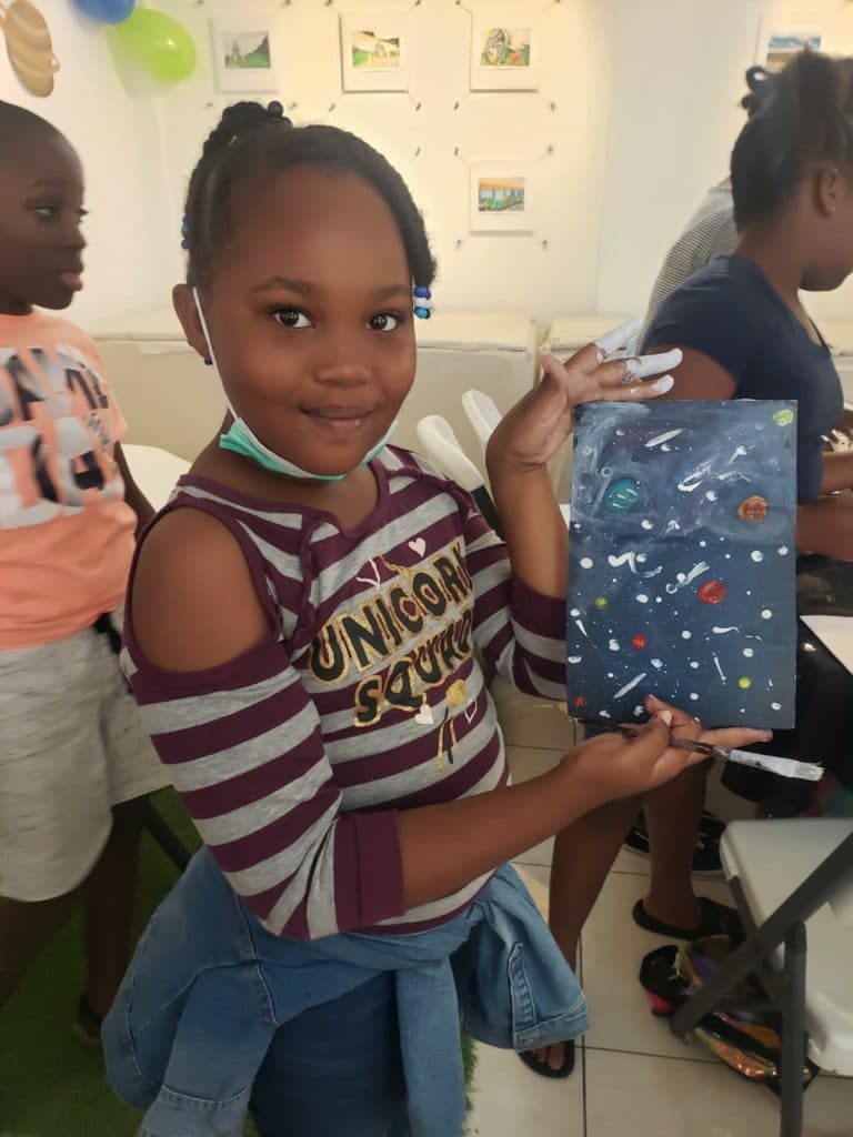 Space painting done by a very happy and creative young girl